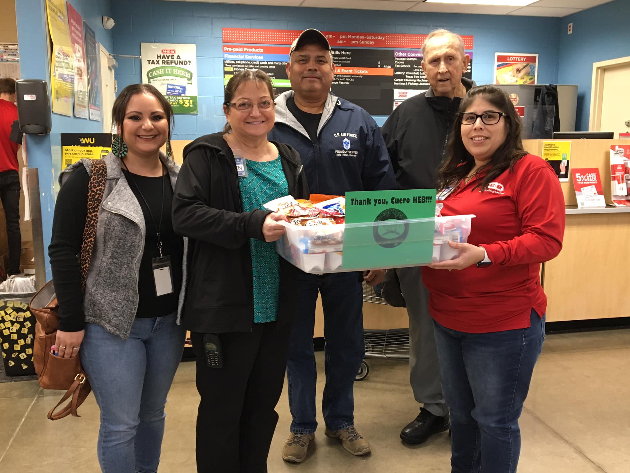 December Events Committee presents “thank you” snack care package to H-E-B Grocery of Cuero
