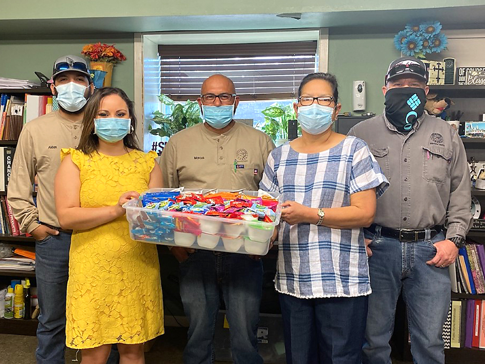 Photo of December Events Committee presenting “thank you” snack care package to City of Cuero Electrical Department